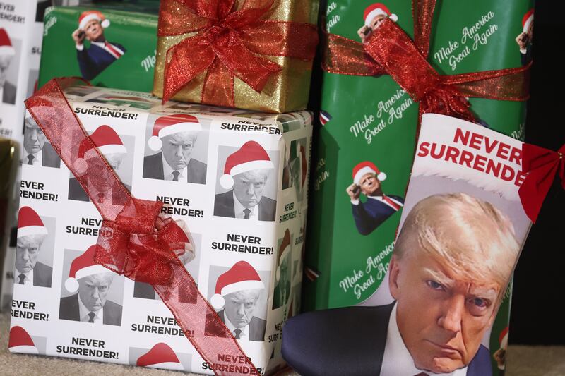 Gifts wrapped in Christmas wrapping paper featuring the likeness of Republican presidential candidate former U.S. President Donald Trump sit on the stage during a rally hosted by the former president on December 19, 2023 in Waterloo, Iowa. Iowa Republicans will be the first to select their party's nomination for the 2024 presidential race, when they go to caucus on January 15, 2024. (Photo by Scott Olson/Getty Images)