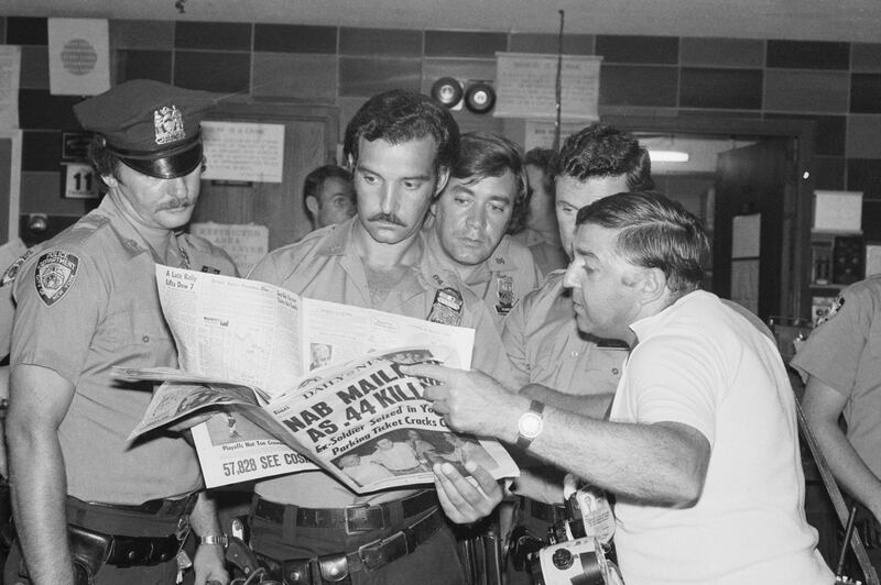Policemen involved in the "Son of Sam" manhunt read about his capture on August 11, 1977.