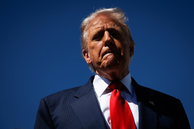 WEST PALM BEACH, FLORIDA - OCTOBER 31: US President Donald Trump speaks to reporters as he arrives at Palm Beach International Airport on October 31, 2025 in West Palm Beach, Florida. Trump is spending the weekend at his Mar-A-Lago estate in Palm Beach, Florida. (Photo by Samuel Corum/Getty Images)