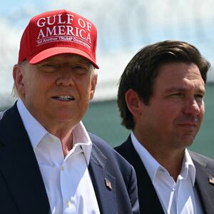 (L/R) US President President Donald Trump and Florida Governor Ron DeSantis tour a migrant detention center, dubbed "Alligator Alcatraz," located at the site of the Dade-Collier Training and Transition Airport in Ochopee, Florida on July 1, 2025. President Trump is visiting a migrant detention center in a reptile-infested Florida swamp dubbed "Alligator Alcatraz." Trump will attend the opening of the 5,000-bed facility -- located at an abandoned airfield in the Everglades wetlands -- part of his expansion of deportations of undocumented migrants, his spokeswoman said. (Photo by ANDREW CABALLERO-REYNOLDS / AFP) (Photo by ANDREW CABALLERO-REYNOLDS/AFP via Getty Images)