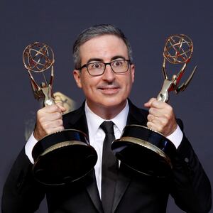 Comedian John Oliver poses with the awards for outstanding writing for a variety series and outstanding variety talk series, for "Last Week Tonight With John Oliver", at the 73rd Primetime Emmy Awards in Los Angeles, U.S., September 19, 2021