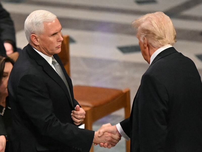 Pence shakes hands with Trump before a State Funeral Service for former US President Jimmy Carter at the Washington National Cathedral in Washington, DC.