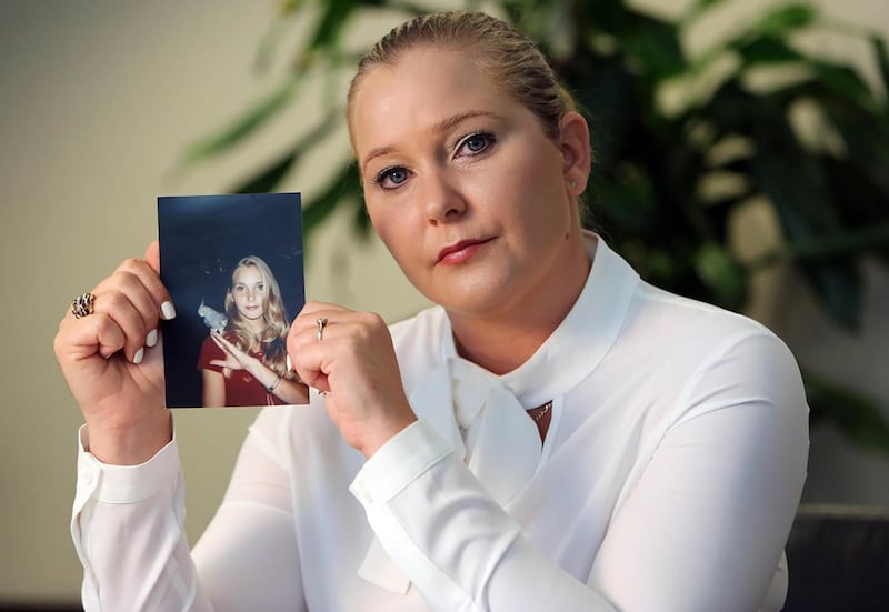 Virginia Giuffre, with a photo of herself as a teen, when she says she was abused by Jeffrey Epstein, Ghislaine Maxwell and Prince Andrew.