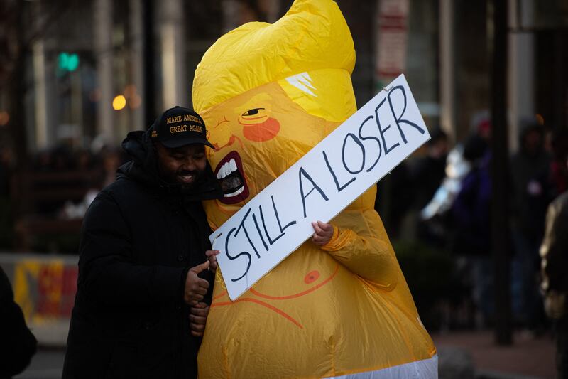 A protestor in a satirical Donald Trump costume poses with a Trump supporter in Washington, D.C., on January 20, 2025.