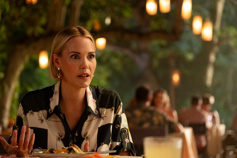 A woman at a dining table.