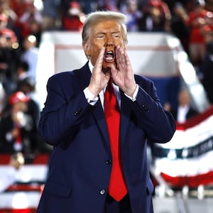Donald Trump shouts from the stage at the conclusion of a campaign rally at the J.S. Dorton Arena on November 04, 2024 in Raleigh, North Carolina.