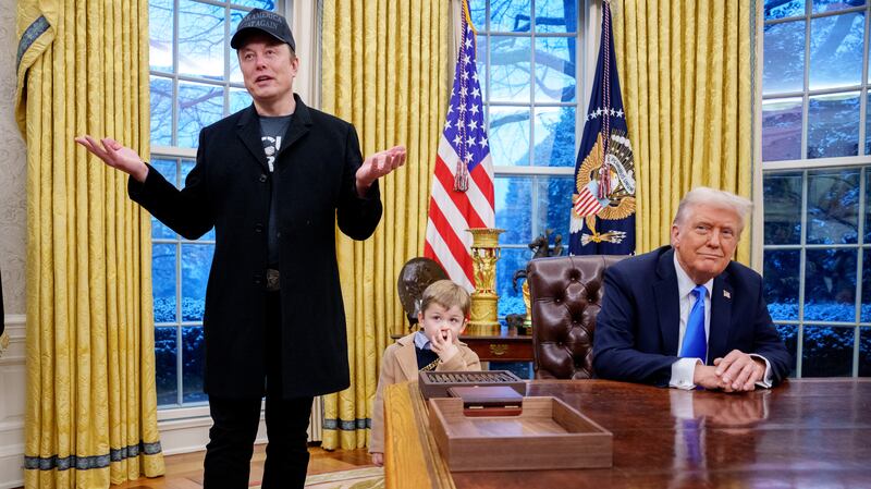 Musk holds court while Trump sits at his desk