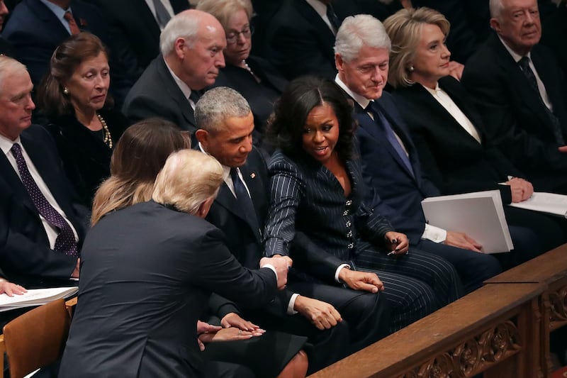 President Donald Trump and first lady Melania Trump greet former President Barack Obama and Michelle Obama at the state funeral for former President George H.W. Bush at the National Cathedral December 05, 2018 in Washington, DC.