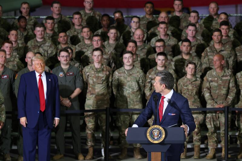 Defense Secretary Pete Hegseth turns to President Donald Trump as he speaks during a visit Selfridge Air National Guard Base in Michigan on April 29, 2025.