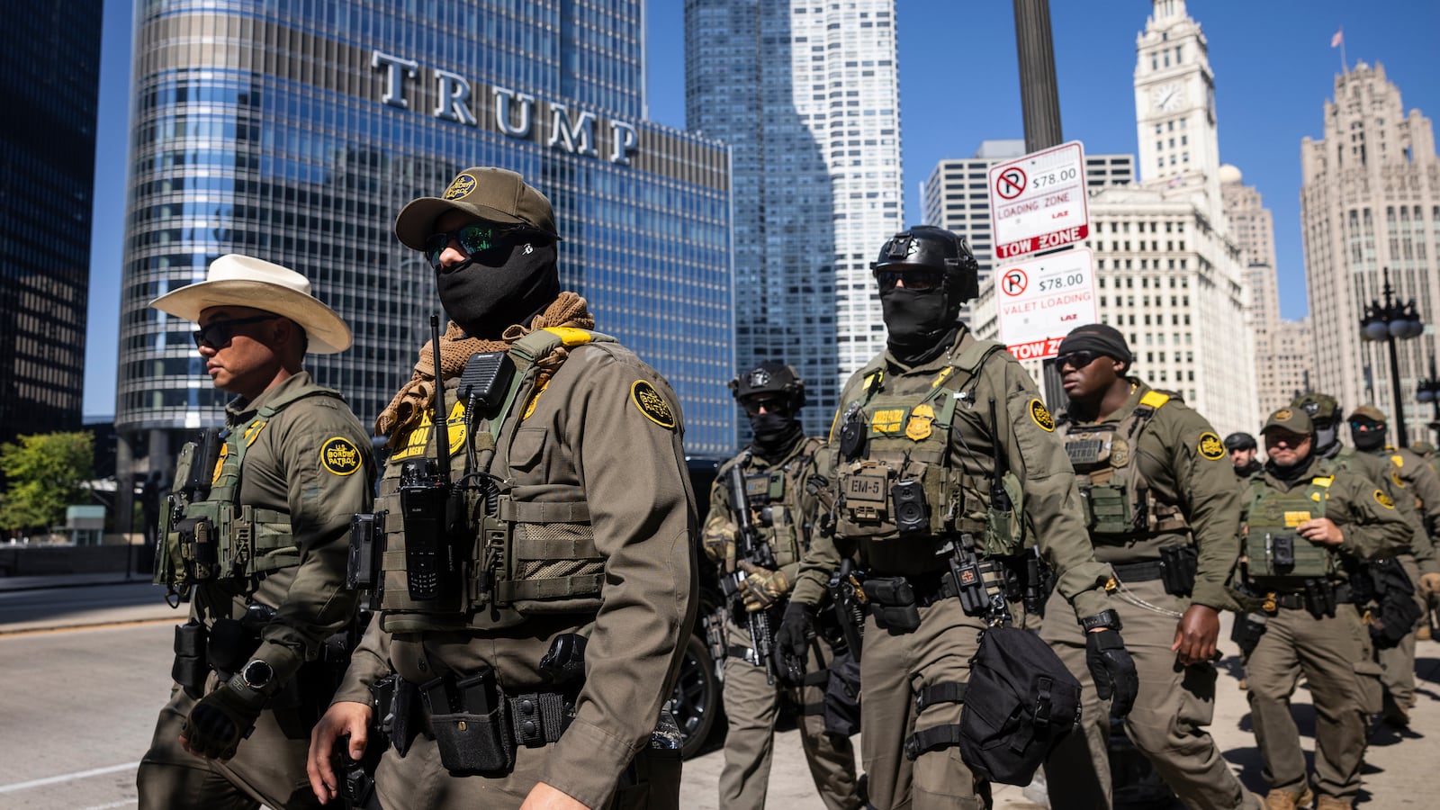 Federal agents walk along West Wacker Drive in the Loop, Sunday.