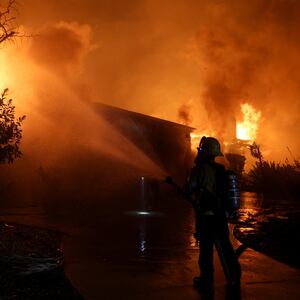 A firefighter works to extinguish flames as the Eaton Fire burns in Pasadena, California, U.S. January 8, 2025.