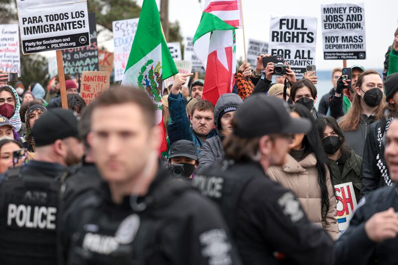 A person gives the middle finger after police officers made an arrest during a march against ICE in Seattle, Washington, on February 8, 2025.
