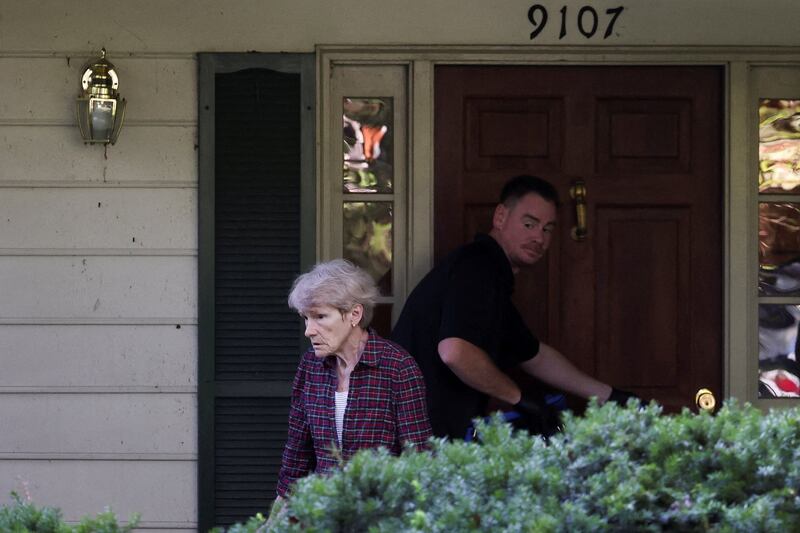 Gretchen Smith Bolton, wife of the former White House national security adviser John Bolton, stands in front of Bolton's house as it is searched by FBI members, in Bethesda, MD on August 22, 2025.