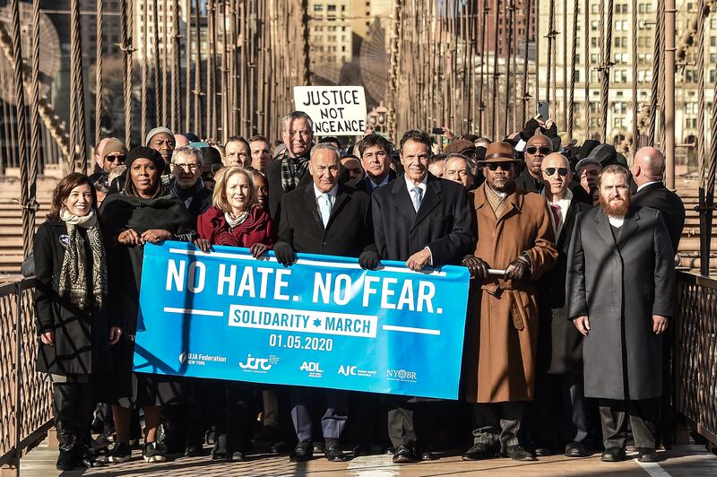 Letitia James, Kirsten Gillibrand, Bill De Blasio, Chuck Schumer, and Andrew Cuomo march across the Brooklyn Bridge at the Jewish Solidarity March on January 05, 2020 in New York City.