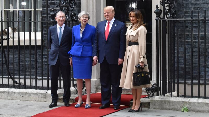 Philip May, UK Prime Minister Theresa May, Donald Trump and Melania pose in front of No. 10 Downing Street in 2019. Melania is holding a black Birking bag.