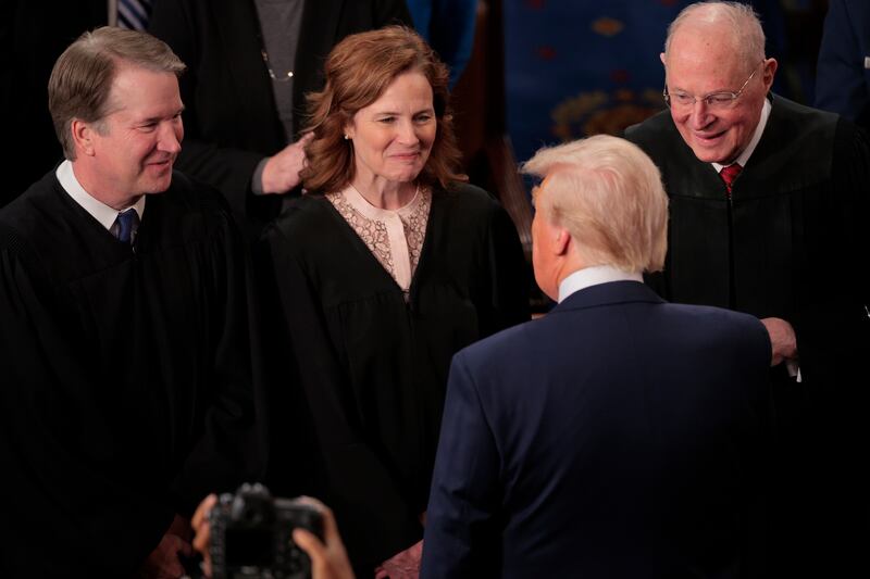 WASHINGTON, DC - MARCH 04: U.S. Supreme Court Associate Justices Brett Kavanaugh (L) and Amy Coney Barrett and former Associate Justice Anthony Kennedy talk with President Donald Trump as he arrives to address to a joint session of Congress at the U.S. Capitol on March 04, 2025 in Washington, DC. During his first address to Congress since returning to the White House for his second term, Trump outlined his legislative agenda, including $4 trillion in tax cuts, shrinking the size of the government and securing the southern border. (Photo by Chip Somodevilla/Getty Images)