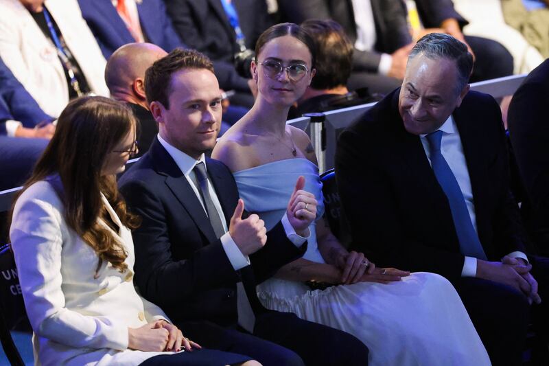 Doug Emhoff (right) sits with his children Ella and Cole (center) on Day 4 of the Democratic National Convention in Chicago, Illinois.