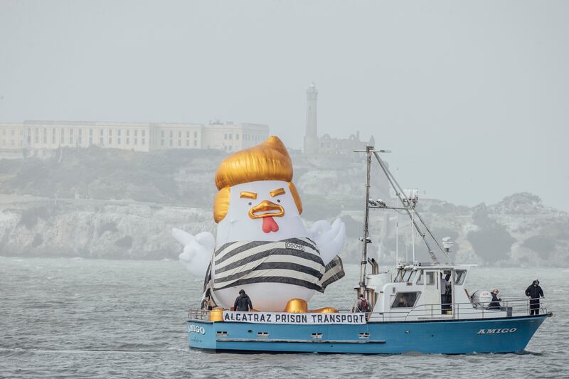 An inflatable caricature known as the Trump Chicken is seen aboard a ship traveling past Alcatraz Island and the Marina Green, as supporters of former U.S. President Donald Trump rally nearby ahead of a campaign fundraiser, in San Francisco, Thursday, June 6, 2024. (Photo by Stephen Lam/San Francisco Chronicle via Getty Images)