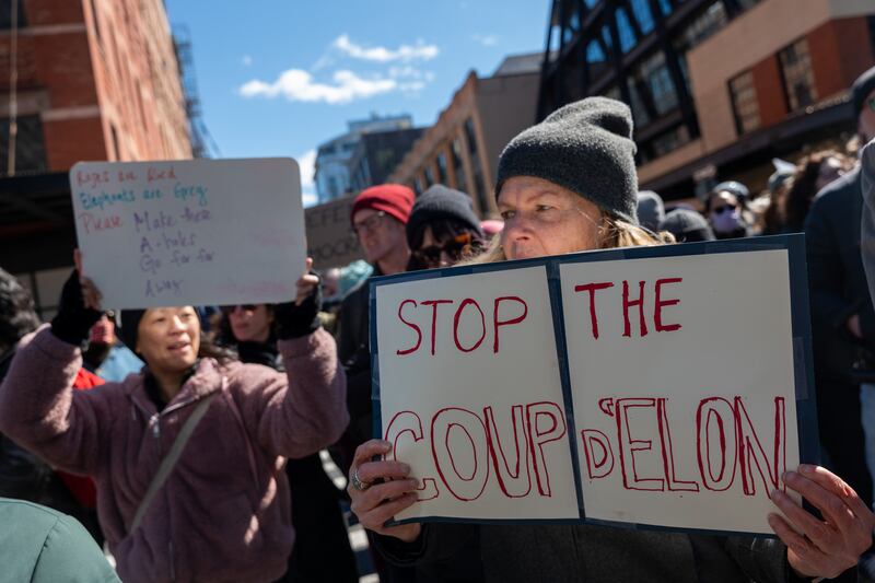 Protesters gather outside of a Manhattan Tesla dealership to demonstrate against Tesla CEO Elon Musk on Saturday.