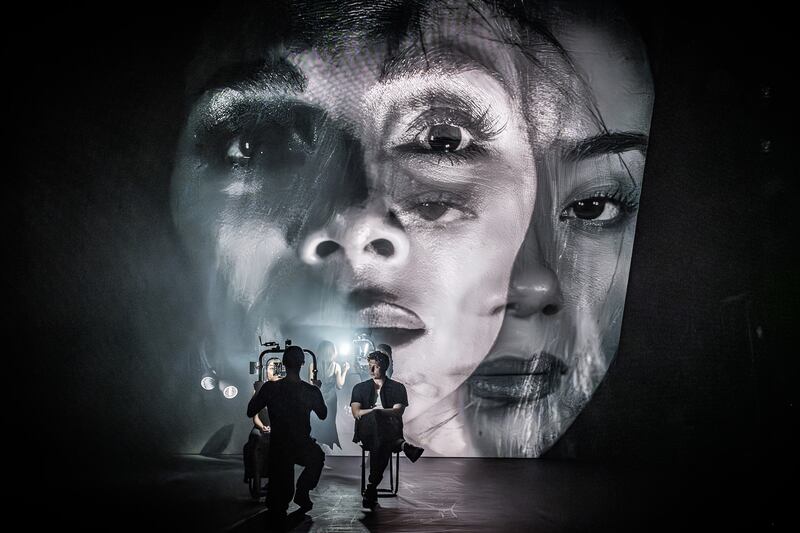 (Projected onto the Screen L to R): Nicole Scherzinger, Hannah Yun Chamberlain, with Tom Francis (seated) as Joe Gillis in Sunset Blvd.