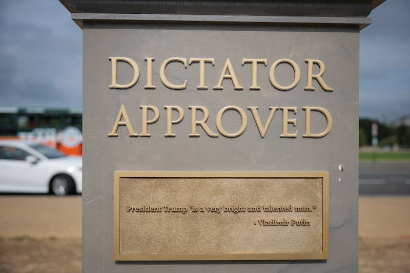 A plaque on the "Dictator Approved" statue shows a quote from Vladimir Putin: "President Trump is a very bright and talented man."