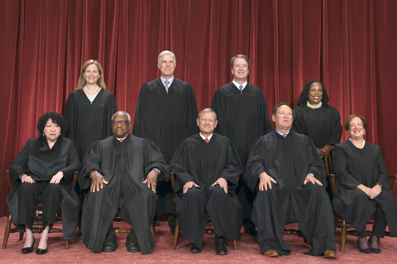 The nine Supreme Court justices seated in their robes.