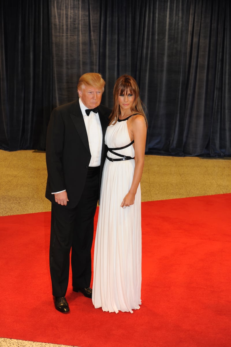 Donald Trump and Melania Trump pose on the red carpet as guests make their way to the White House Correspondents Dinner at the Washington Hilton Hotel on April 30, 2011, in Washington, D.C.