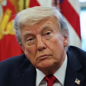 U.S. President Donald Trump looks on next to wounded veterans (not pictured) before signing executive orders in the Oval Office at the White House in Washington, D.C., U.S., April 23, 2025. REUTERS/Leah Millis