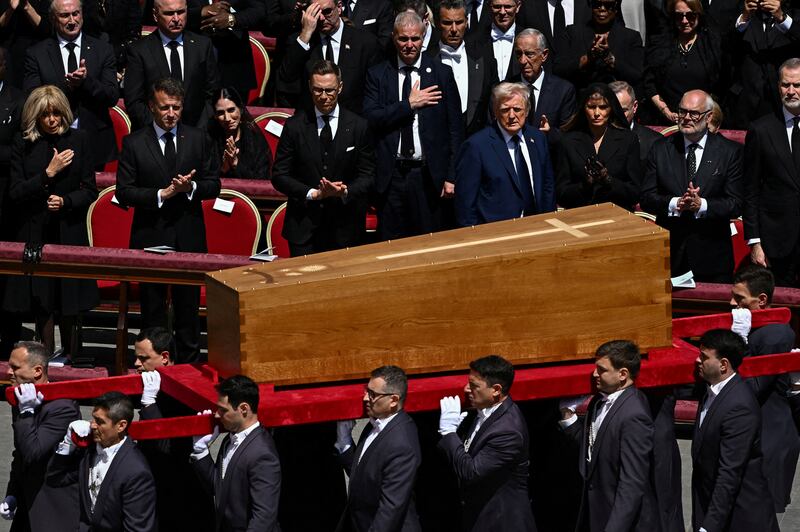 U.S. President Donald Trump, first lady Melania Trump, France's President Emmanuel Macron and his wife Brigitte Macron stand as the coffin is carried on the day of the funeral of Pope Francis in St. Peter's Square at the Vatican, April 26, 2025. REUTERS/Dylan Martinez
