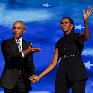 Former U.S. first lady Michelle Obama greets her husband, former U.S. President Barack Obama, on stage during Day 2 of the Democratic National Convention (DNC) in Chicago, Illinois, U.S., August 20, 2024.
