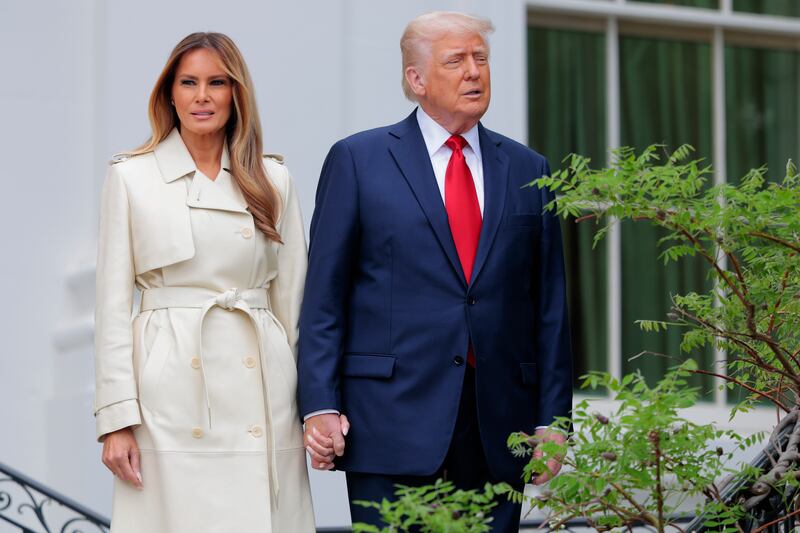 WASHINGTON, DC - APRIL 21: U.S. President Donald Trump, and first lady Melania Trump walk down steps to view the White House Egg Roll on the South Lawn of the White House on April 21, 2025 in Washington, DC. The White House is expecting thousands of children and adults to participate in the annual tradition of rolling colored eggs down the White House lawn, which was started by President Rutherford B. Hayes in 1878. (Photo by Anna Moneymaker/Getty Images)