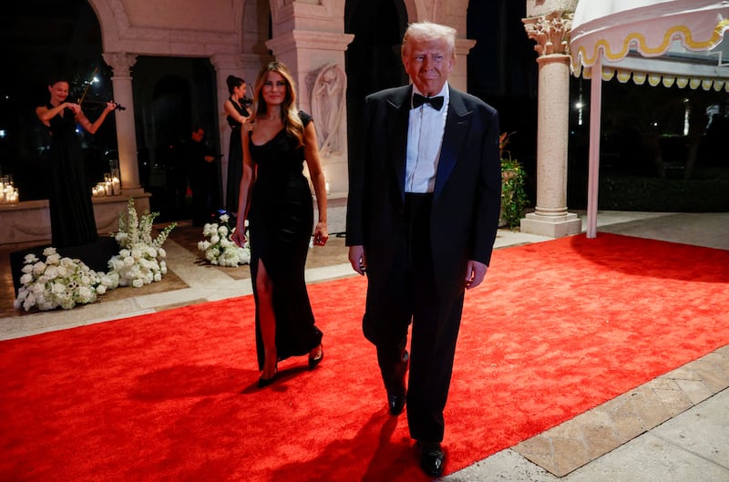 U.S. President-elect Donald Trump, accompanied by his wife Melania, attends a New Year's Eve event at Mar-a-Lago in Palm Beach, Florida, U.S., December 31, 2024. REUTERS/Marco Bello