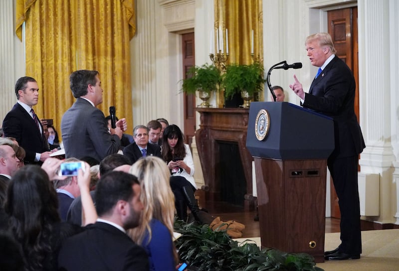 US President Donald Trump (R) gets into a heated exchange with CNN chief White House correspondent Jim Acosta (C) as NBC correspondent Peter Alexander (L) looks on during a post-election press conference in the East Room of the White House in Washington, DC on November 7, 2018.