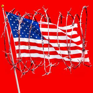 A photo illustration of the American flag wrapped in barbed wire.