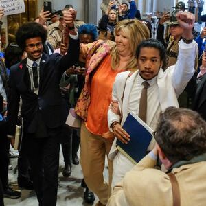 Tennessee State Representative Justin Pearson, Gloria Johnson and Justin Jones hold hands as they walk in the State House.