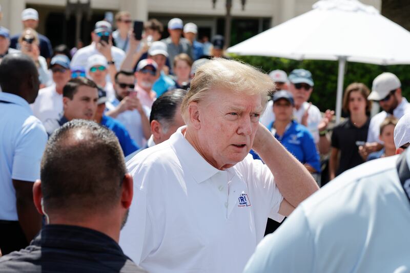 Donald Trump walks toward the practice green before the final round of LIV Golf Miami tournament in April 2024.