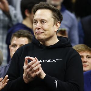 Elon Musk claps as U.S. President Donald Trump enters the stadium during the Division I Men's Wrestling Championship held at the Wells Fargo Center on March 22, 2025 in Philadelphia, Pennsylvania.
