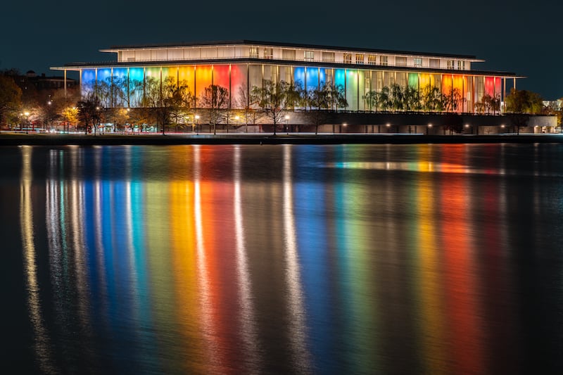 WASHINGTON, DC - DECEMBER 01: Reflected in the Potomac River, the exterior of the John F. Kennedy Center of the Performing Arts building is lit up in multiple colors in advance of the annual Kennedy Center Honors on December 1, 2024, in Washington, DC. (Photo by J. David Ake/Getty Images)