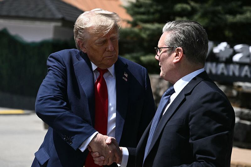 US President Donald Trump (L) shakes hands with British Prime Minister Keir Starmer as they speak to reporters after meeting during the Group of Seven (G7) Summit at the Pomeroy Kananaskis Mountain Lodge in Kananaskis, Alberta, Canada on June 16, 2025. (Photo by Brendan SMIALOWSKI / AFP) (Photo by BRENDAN SMIALOWSKI/AFP via Getty Images)