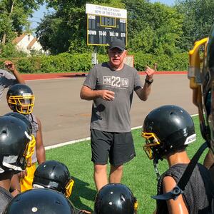 Tim Walz, then a candidate for Minnesota governor, gives a pep talk to football players at Como Park Senior High School in St. Paul in 2018. 