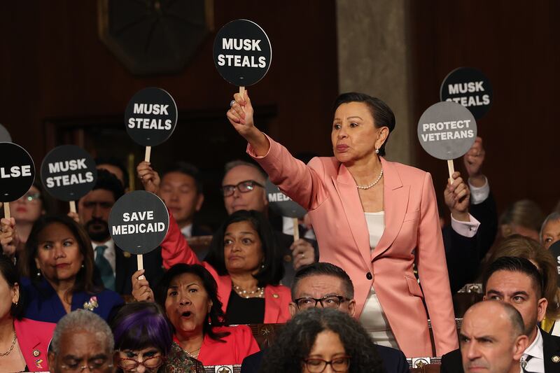 Rep. Nydia Velázquez (D-NY) and fellow Democrats wave as President Donald Trump address a joint session of Congress at the U.S. Capitol on March 4, 2025 in Washington, D.C.
