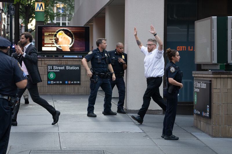 Office workers flee the area of an active shooter in Midtown Manhattan, Monday, June 28, 2025, in New York City.