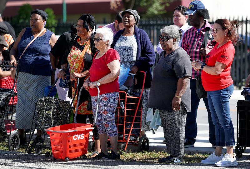 People receive groceries in Flordia from the Curley's House Food Bank days before the Supplemental Nutrition Assistance Program (SNAP) benefits may expire