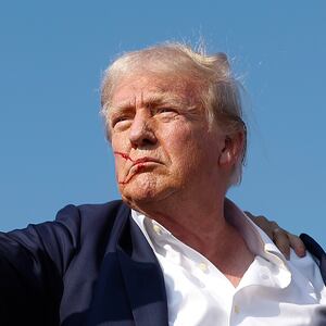 BUTLER, PENNSYLVANIA - JULY 13: Republican presidential candidate former President Donald Trump pumps his fist as he is rushed offstage by U.S. Secret Service agents after being grazed by a bullet during a rally on July 13, 2024 in Butler, Pennsylvania. Butler County district attorney Richard Goldinger said the shooter is dead after injuring former U.S. President Donald Trump, killing one audience member and injuring another in the shooting. (Photo by Anna Moneymaker/Getty Images)