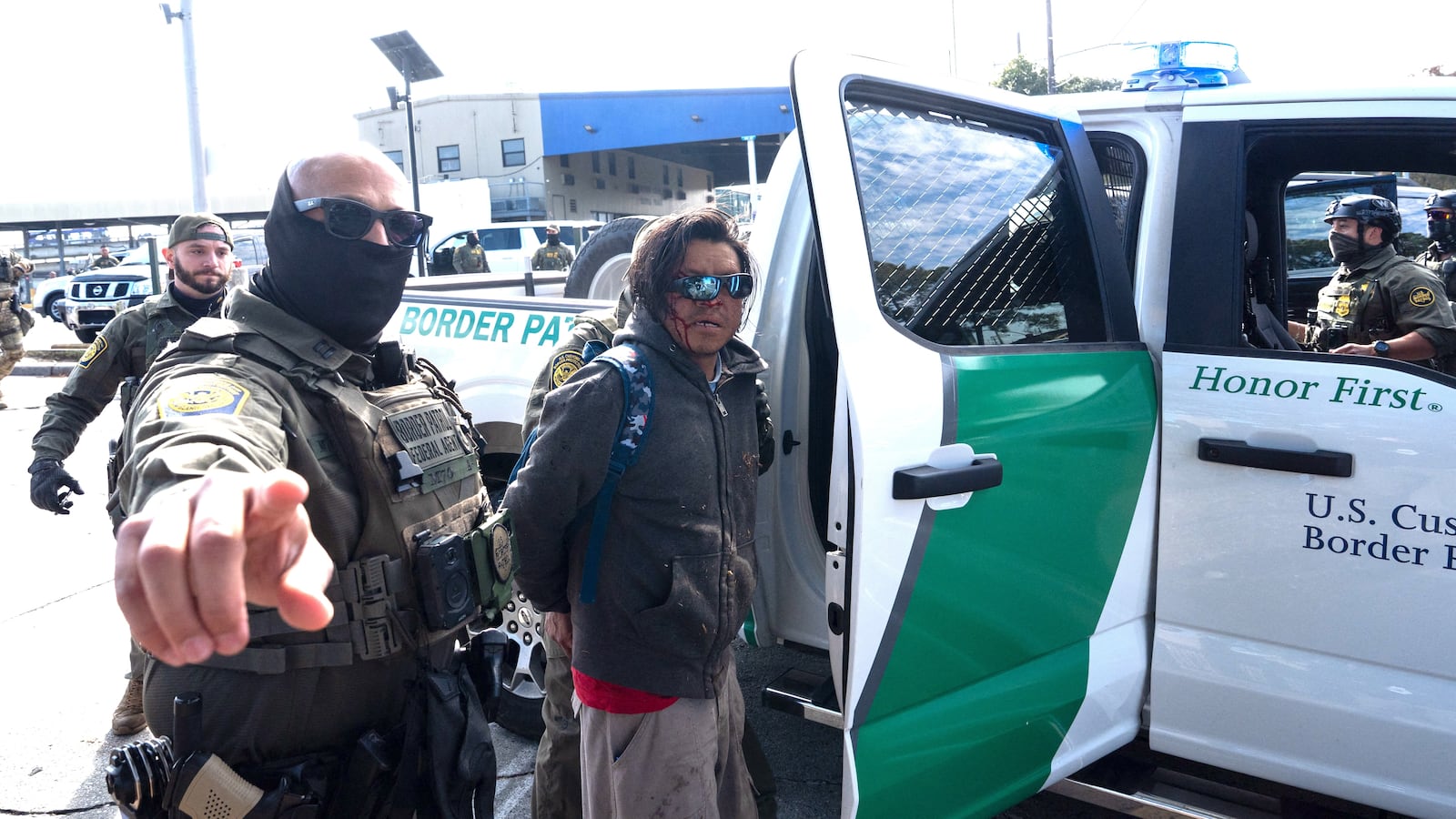 A person is detained by US Customs and Border Patrol (CBP) agents near a Lowe's hardware store in New Orleans, Louisiana