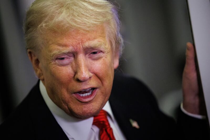 President Donald Trump speaks to reporters aboard Air Force One en route to the White House on November 2, 2025.