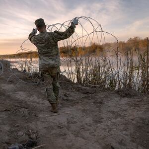 Texas National Guard soldiers install additional razor wire lie along the Rio Grande on January 10, 2024 in Eagle Pass, Texas.
