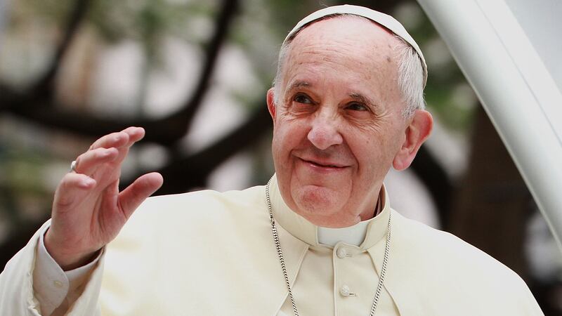 Pope Francis waves to thousands of followers as he arrives at the Manila Cathedral on January 16, 2015 in Manila, Philippines.