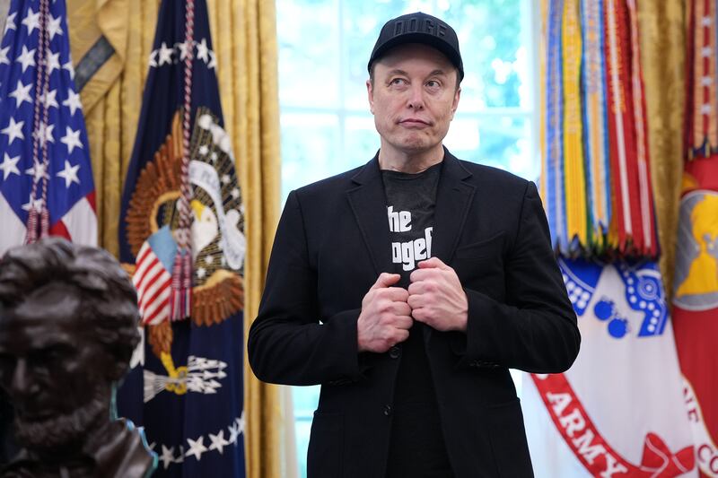 WASHINGTON, DC - MAY 30: Tesla CEO Elon Musk listens as U.S. President Donald Trump speaks to reporters in the Oval Office of the White House on May 30, 2025 in Washington, DC. Musk, who served as an adviser to Trump and led the Department of Government Efficiency, announced he would leave his role the Trump administration to refocus on his businesses. (Photo by Kevin Dietsch/Getty Images)
