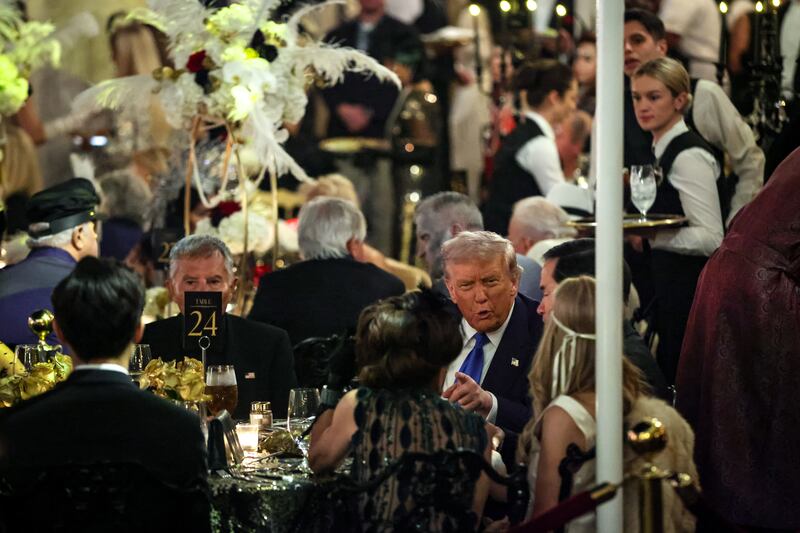 PALM BEACH, FLORIDA - OCTOBER 31: US President Donald Trump talks with guests during a Halloween party at his Mar-a-Lago estate on October 31, 2025 at Palm Beach, Florida. Trump is spending the weekend at his Mar-A-Lago estate in Palm Beach, Florida. (Photo by Samuel Corum/Getty Images)
